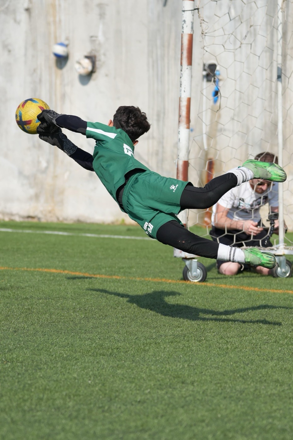 Lucas flying through the air to make a two-handed save
